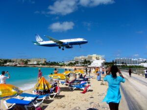 A plane lands in Sint Maarten. Visitors’ water needs come first on many islands that depend on tourism. (Richie Diesterheft/Flickr, CC BY-SA)