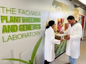 Scientist Shoba Sivasankar, right, receives a package of seeds that journeyed from the International Space Station to the FAO/IAEA Plant Breeding and Genetics Laboratory in Seibersdorf, Austria, in 2023. (Katy Laffan/IAEA)