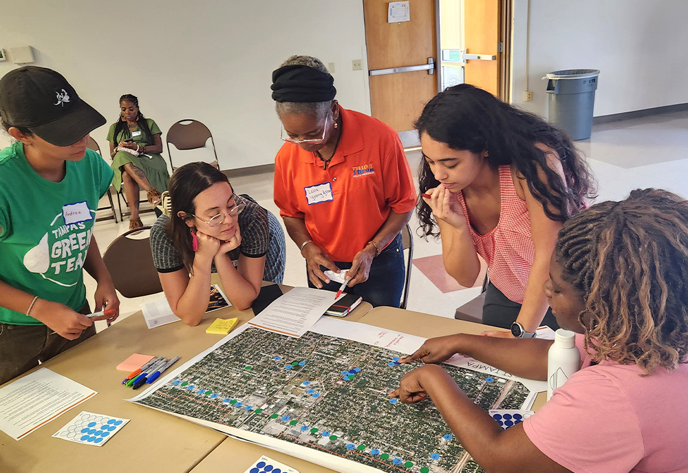 Community members in East Tampa identifying neighborhood amenities and walking distances during the East Tampa community engagement workshop for the heat vulnerability study. (Photo courtesy of USF)