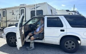 James Pike sits in his car in a grocery store parking lot after Hurricane Helene. Pike and others evacuated a mobile home park in Yankeetown, Florida, which saw 10 feet of storm surge. (Jake Bittle/Grist)