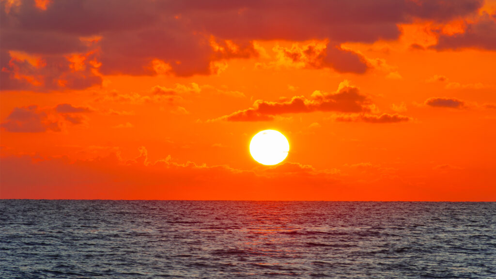 The sun rises over the ocean (iStock image)