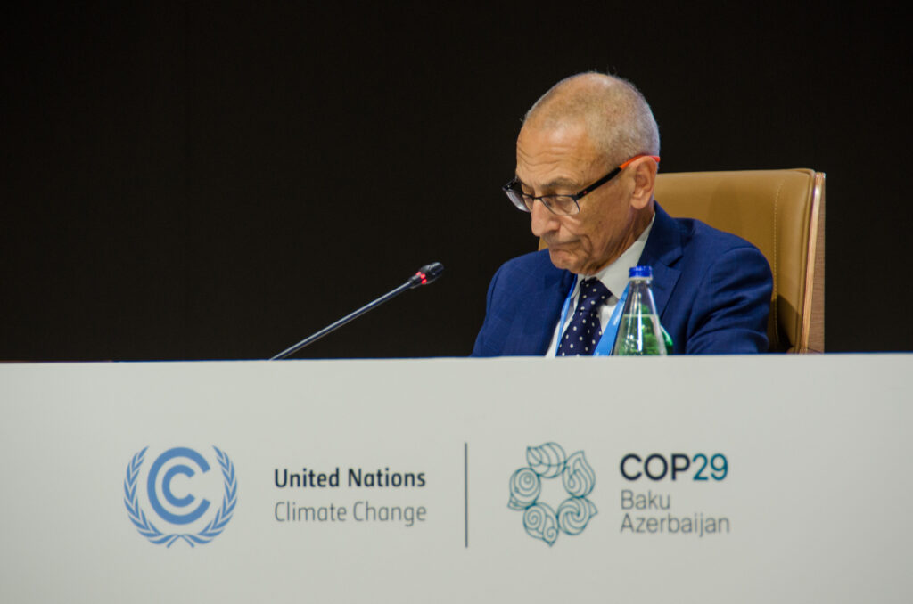 Not to be outdone in the extent to which external agendas and events are driving its COP29 engagement, U.S. climate envoy John Podesta represents a lame-duck American administration and contemplates his own nation’s future role in the climate negotiation process. As atmospheric greenhouse gasses follow an unwavering path ever upward, U.S. politics and commitment, like that of so many other nations, swings from one extreme to the other like a pendulum. While it marks the passage of critical time, a swinging pendulum on average goes nowhere. (Photo by Michal Fidler, text by John Capece)