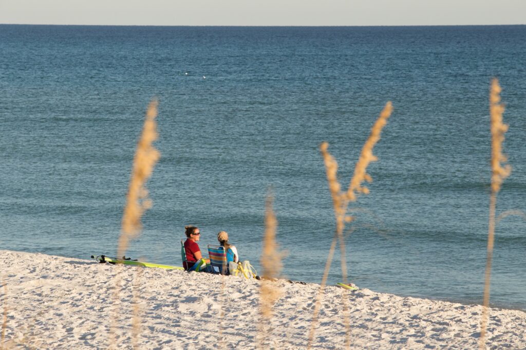 Two women relax on the Navarre Beach shore in the Florida Panhandle. (Tyler Jones, UF/IFAS)